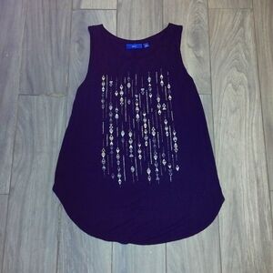 A tank top from APT.9 XS it is a black tank top with gold designs on the front